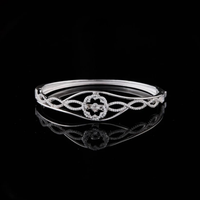 Twisted Design Moissanite Bracelet Featuring a Central Radiant Flower and Pave Detailing